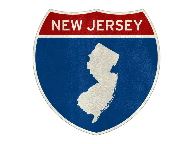 New Jersey interstate highway sign with a white state outline on a blue shield and red banner