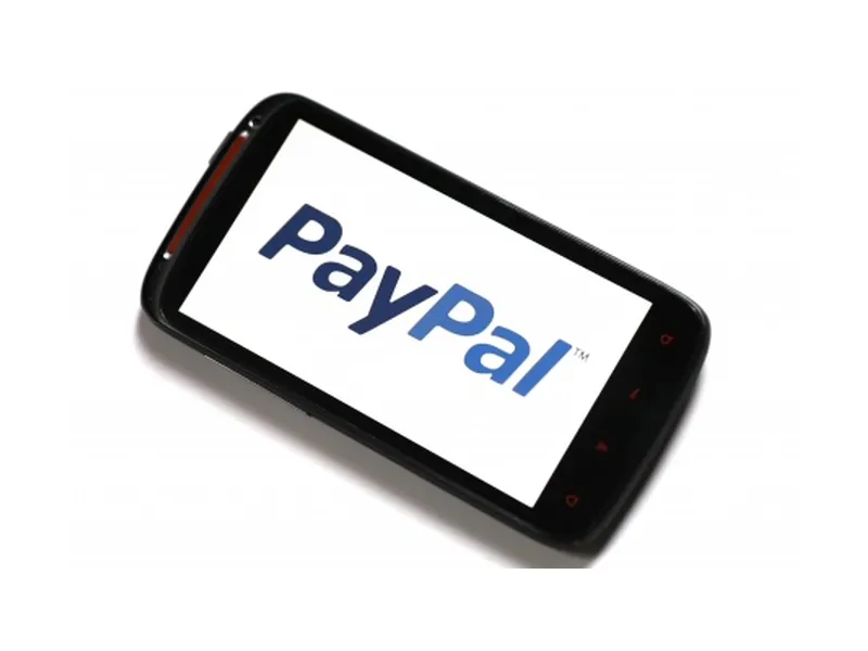 PayPal logo on the screen of a black smartphone photographed against a white background